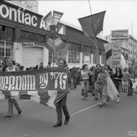 Marchers holding a banner with the text Gay Freedom by ’76 at O’Farrell and Polk streets in San Francisco during the Gay Freedom Day Parade on June 30, 1974