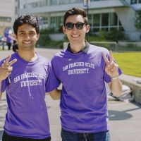 Two smiling students in SFSU t-shirts