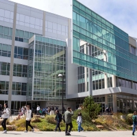 Students walking in front of library