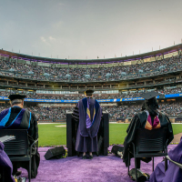 A view from the stage at Commencement looking out at a crowded stadium